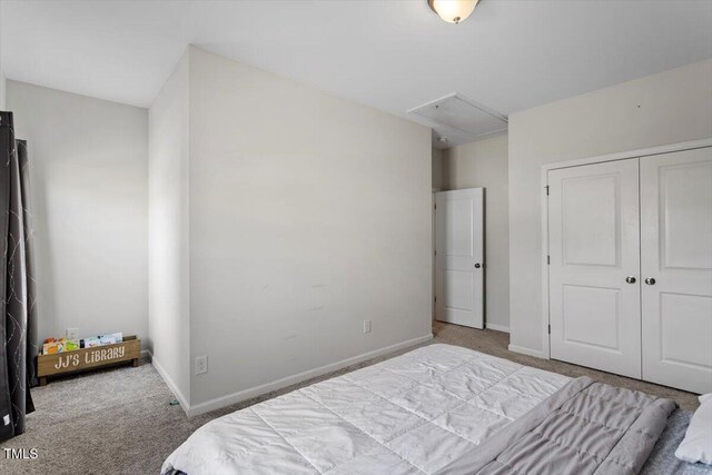 bedroom with attic access, a closet, carpet flooring, and baseboards