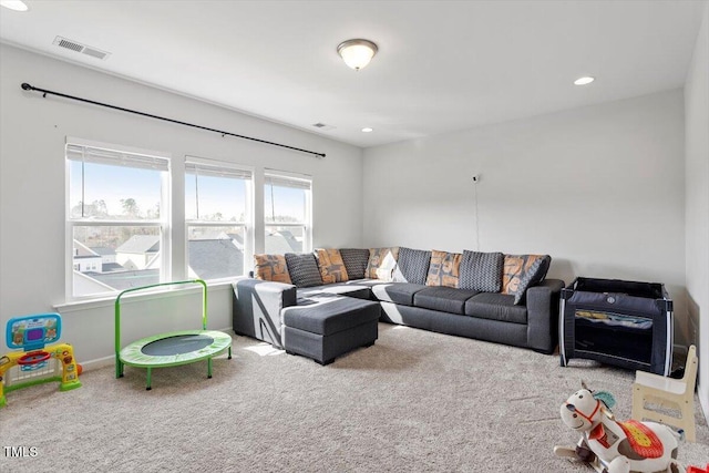 carpeted living room featuring visible vents and recessed lighting