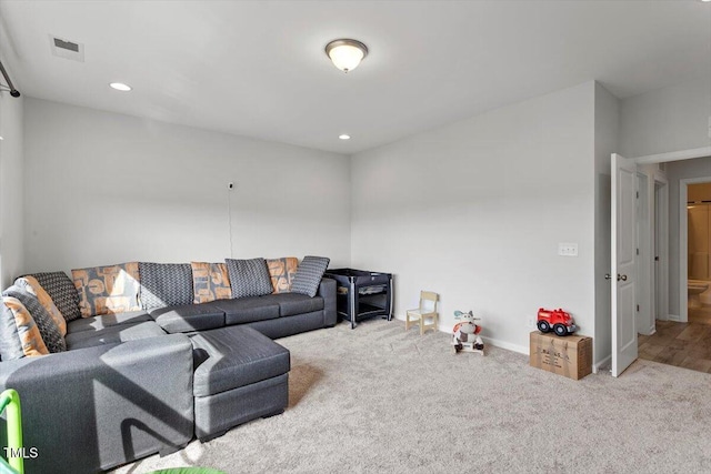 living area featuring carpet floors, recessed lighting, visible vents, and baseboards