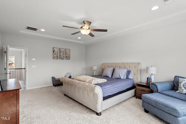 bedroom featuring recessed lighting, a raised ceiling, visible vents, and light carpet