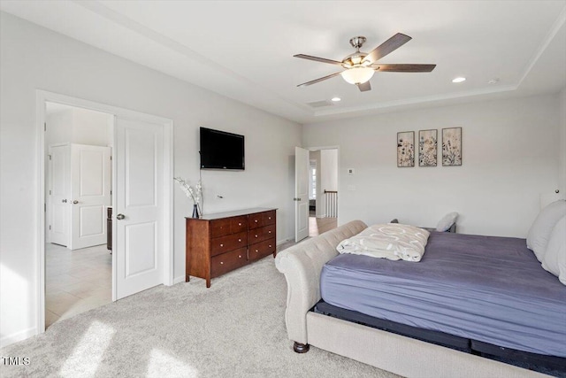 bedroom featuring light carpet, ceiling fan, a raised ceiling, and recessed lighting