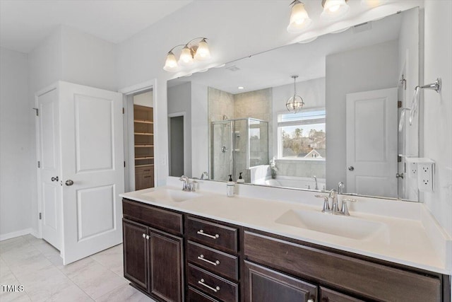 bathroom with double vanity, a sink, a shower stall, and a bath