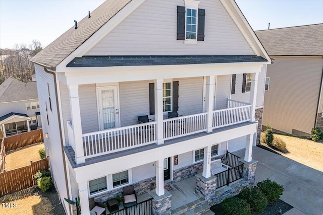 view of front of home with a porch and roof with shingles