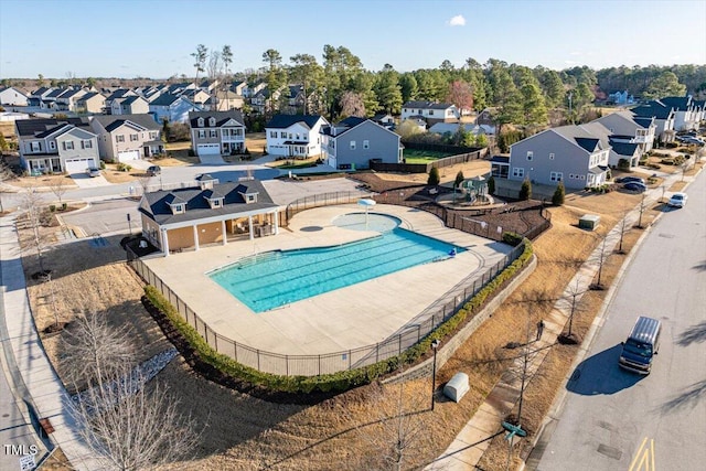 view of pool featuring fence and a residential view