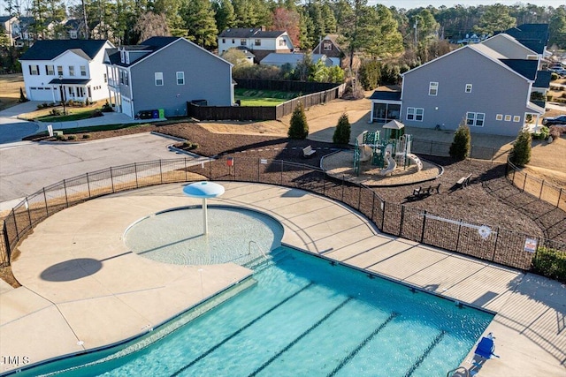 pool featuring a residential view and fence