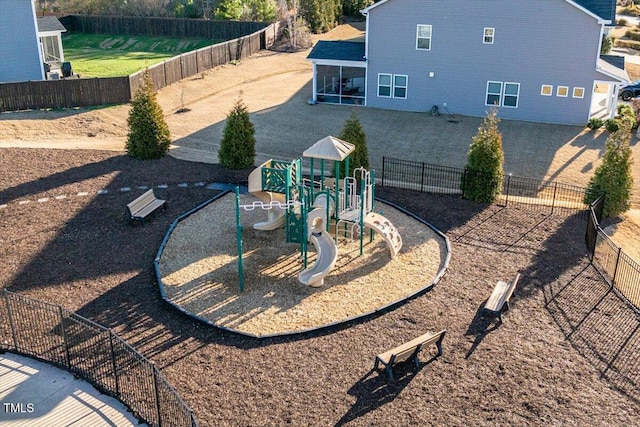 exterior space featuring playground community, fence, and a sunroom