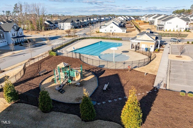 pool with fence and a residential view