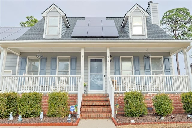 cape cod home with covered porch and solar panels