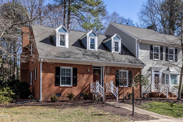 view of front of house with crawl space, brick siding, a chimney, and roof with shingles