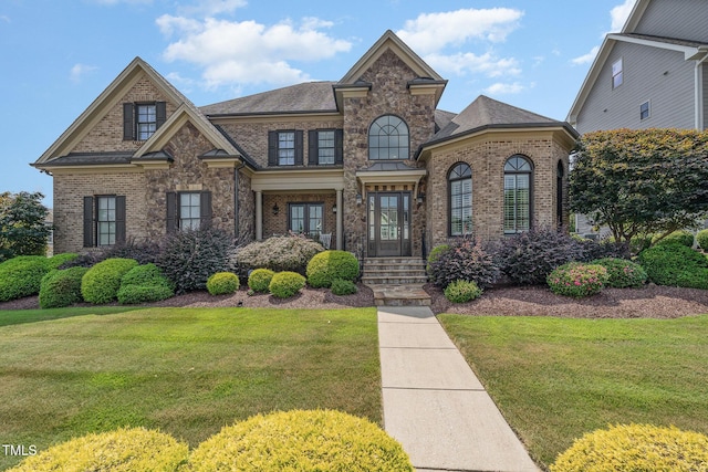 view of front of house with brick siding and a front yard