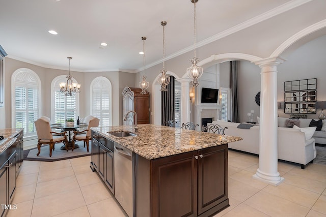 kitchen featuring light tile patterned floors, open floor plan, dishwasher, and a sink