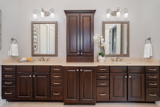 bathroom with double vanity, tile patterned floors, and a sink