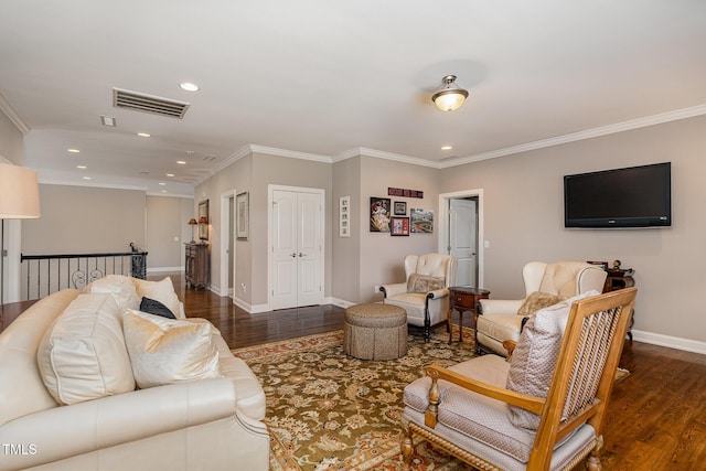 living area featuring visible vents, crown molding, and wood finished floors