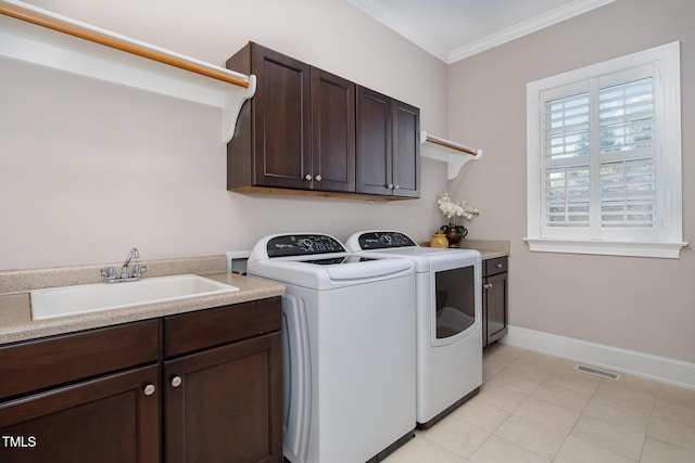 laundry area with visible vents, a sink, washer and dryer, cabinet space, and crown molding