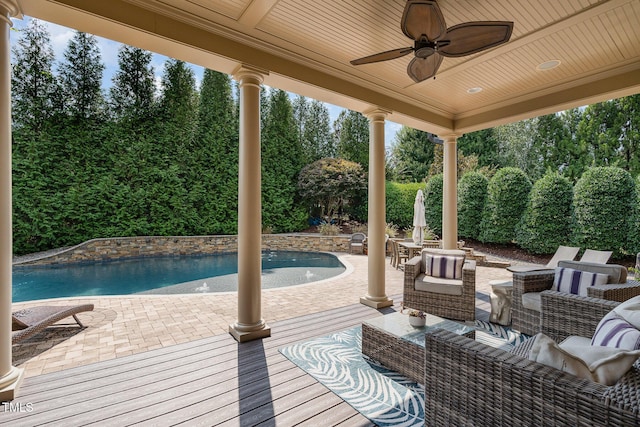 pool with a patio area, an outdoor living space, and a ceiling fan