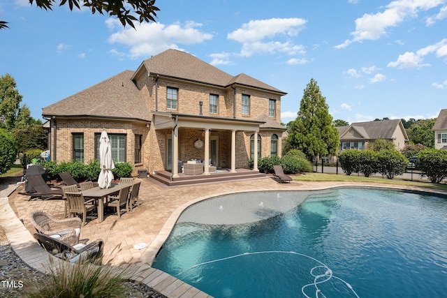 view of pool featuring a patio area, a fenced in pool, and fence