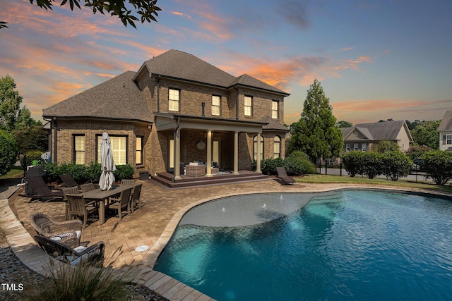 view of swimming pool featuring a fenced in pool, a patio, outdoor dining area, and fence