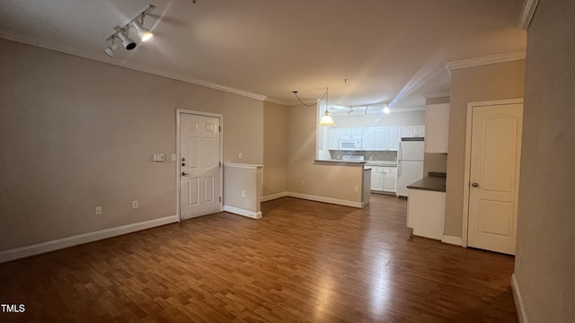 1828 Parkside Village Dr, Clayton, NC 27520 - unfurnished living room with crown molding, track lighting, baseboards, and dark wood-style flooring