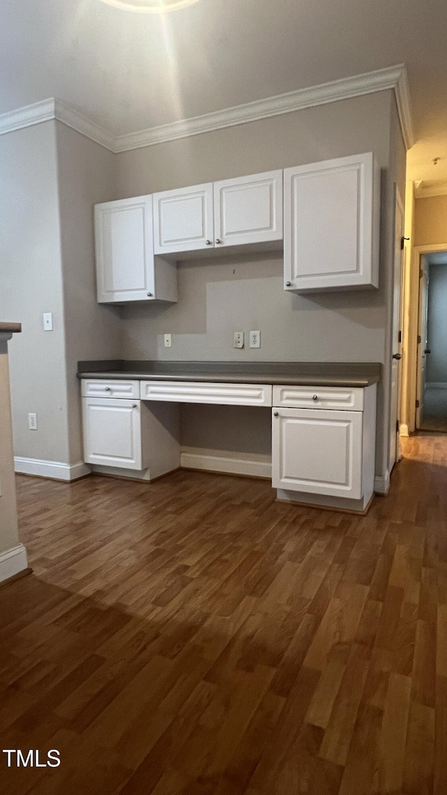 1828 Parkside Village Dr, Clayton, NC 27520 - kitchen with built in desk, crown molding, and dark countertops
