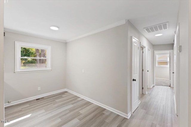 unfurnished room with crown molding and light hardwood / wood-style floors