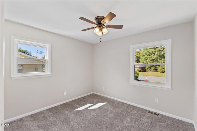 carpeted empty room featuring ceiling fan