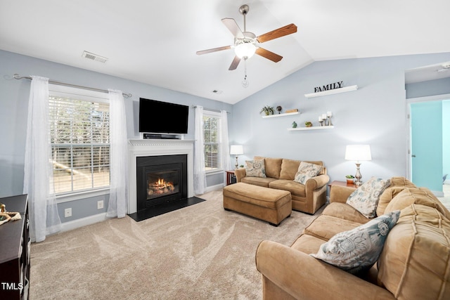 living room with light carpet, lofted ceiling, and ceiling fan