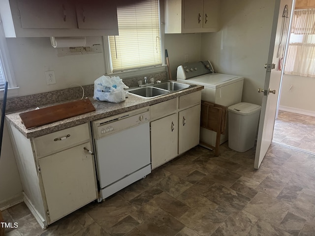 kitchen with white cabinetry, white dishwasher, washer / dryer, and sink