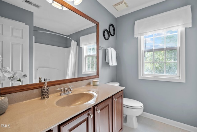 bathroom with a healthy amount of sunlight, visible vents, vanity, and toilet