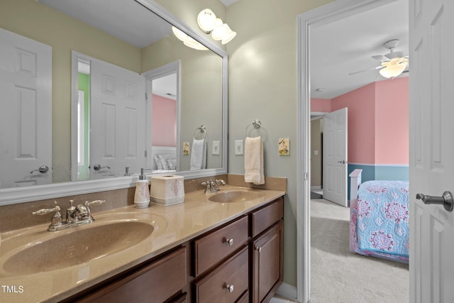 ensuite bathroom with a sink, double vanity, ensuite bath, and a ceiling fan