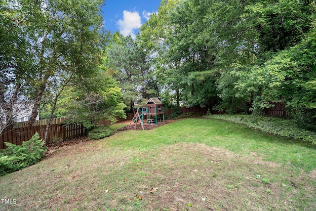 view of yard featuring a playground and a fenced backyard