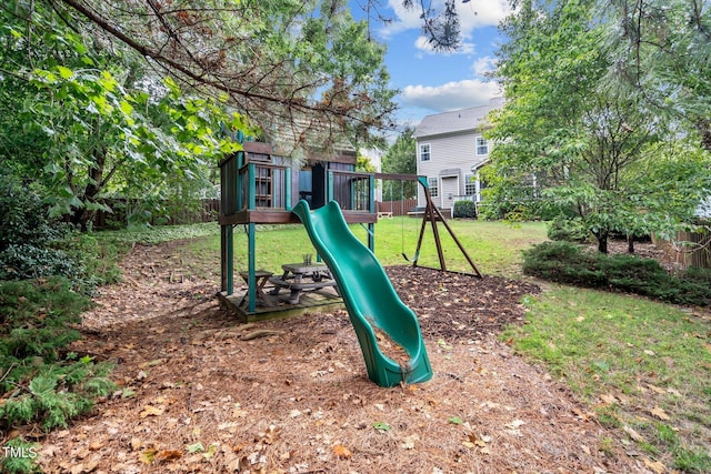 view of play area featuring a lawn and fence