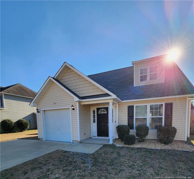 view of front of home featuring a garage and a front lawn