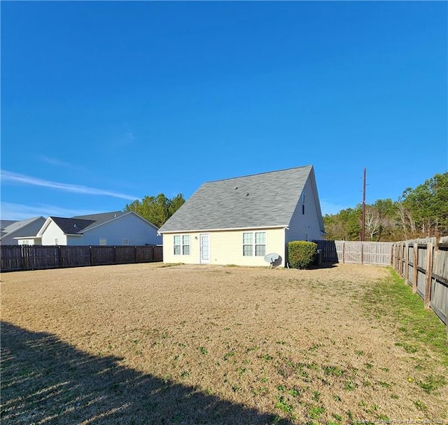 rear view of property with a yard