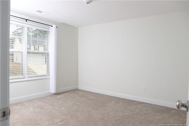 unfurnished room with light colored carpet