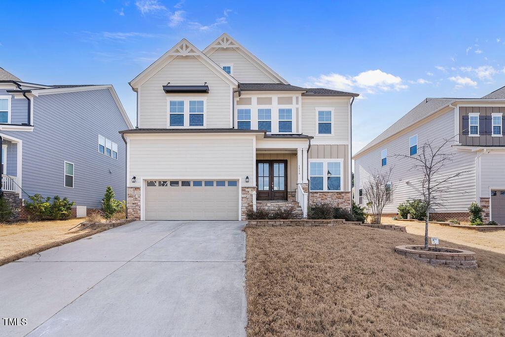 craftsman-style house featuring french doors and a garage