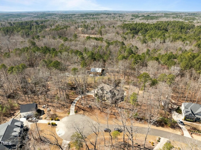 birds eye view of property with a view of trees