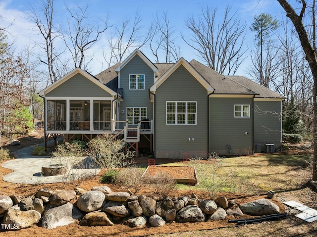 rear view of house featuring central air condition unit, a sunroom, stairs, roof with shingles, and a patio area