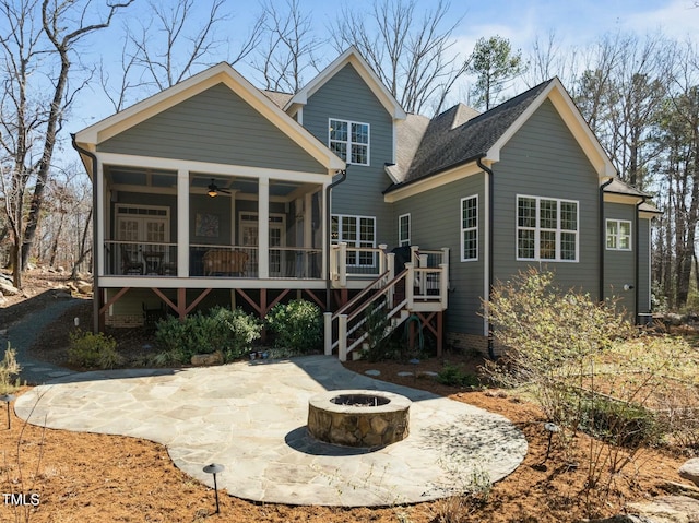 rear view of property with a patio, a sunroom, ceiling fan, a fire pit, and stairs