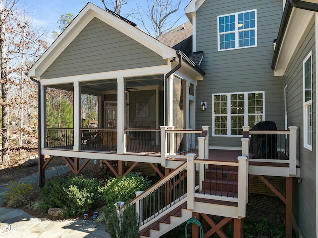 wooden terrace with a sunroom and stairway