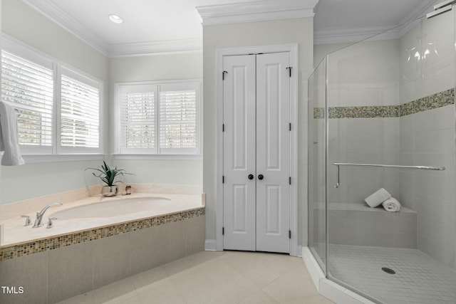 bathroom featuring a garden tub, crown molding, a closet, a shower stall, and tile patterned flooring