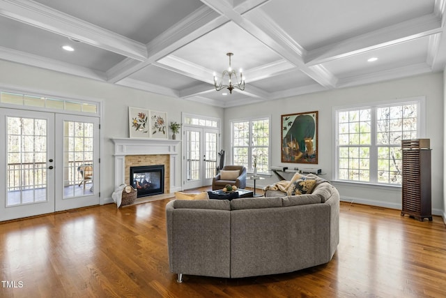 living room with beamed ceiling, coffered ceiling, wood finished floors, and french doors