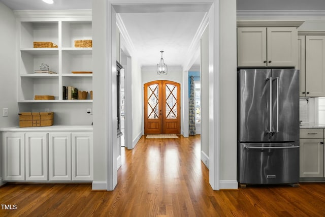 entryway with dark wood-style floors, baseboards, crown molding, and french doors