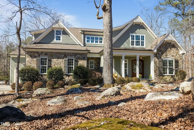 view of front of property with a porch and stone siding