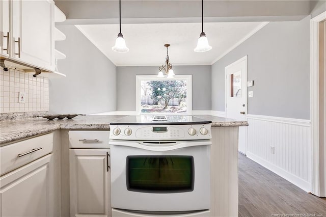 kitchen featuring white cabinetry, hanging light fixtures, ornamental molding, electric stove, and light stone countertops