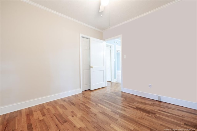 empty room featuring crown molding, ceiling fan, and hardwood / wood-style flooring