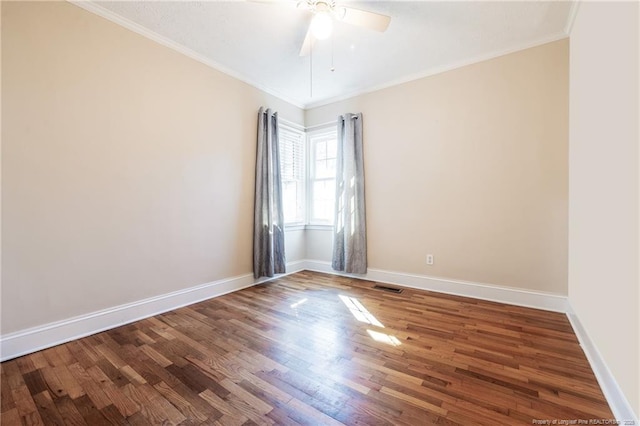 empty room featuring crown molding, wood-type flooring, and ceiling fan