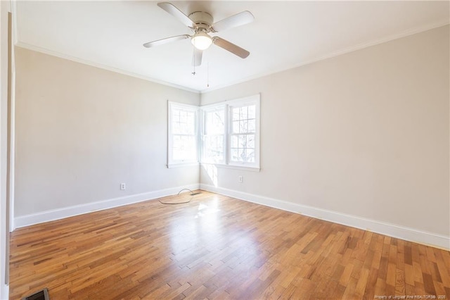 empty room featuring crown molding, ceiling fan, and hardwood / wood-style flooring