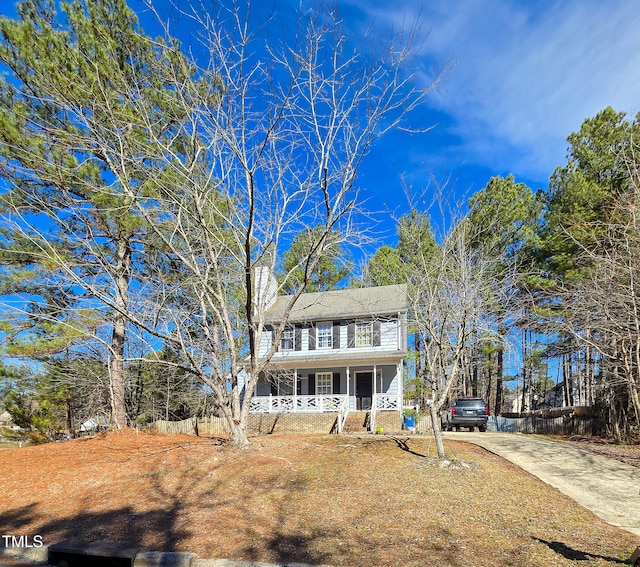 colonial inspired home featuring covered porch