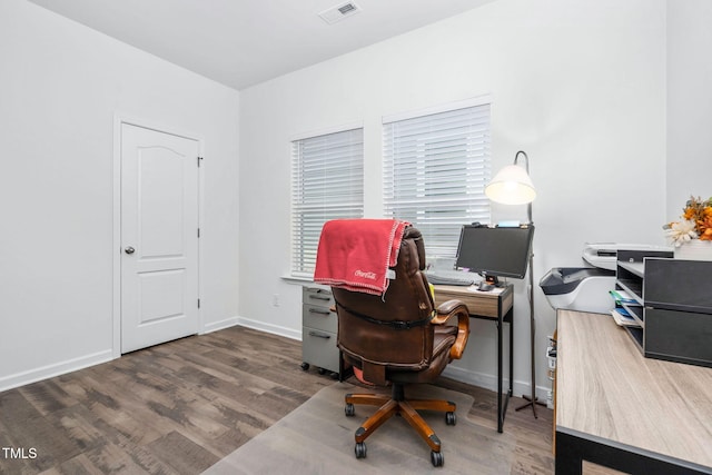 home office with visible vents, baseboards, and wood finished floors