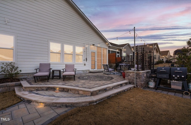 patio terrace at dusk featuring a fire pit